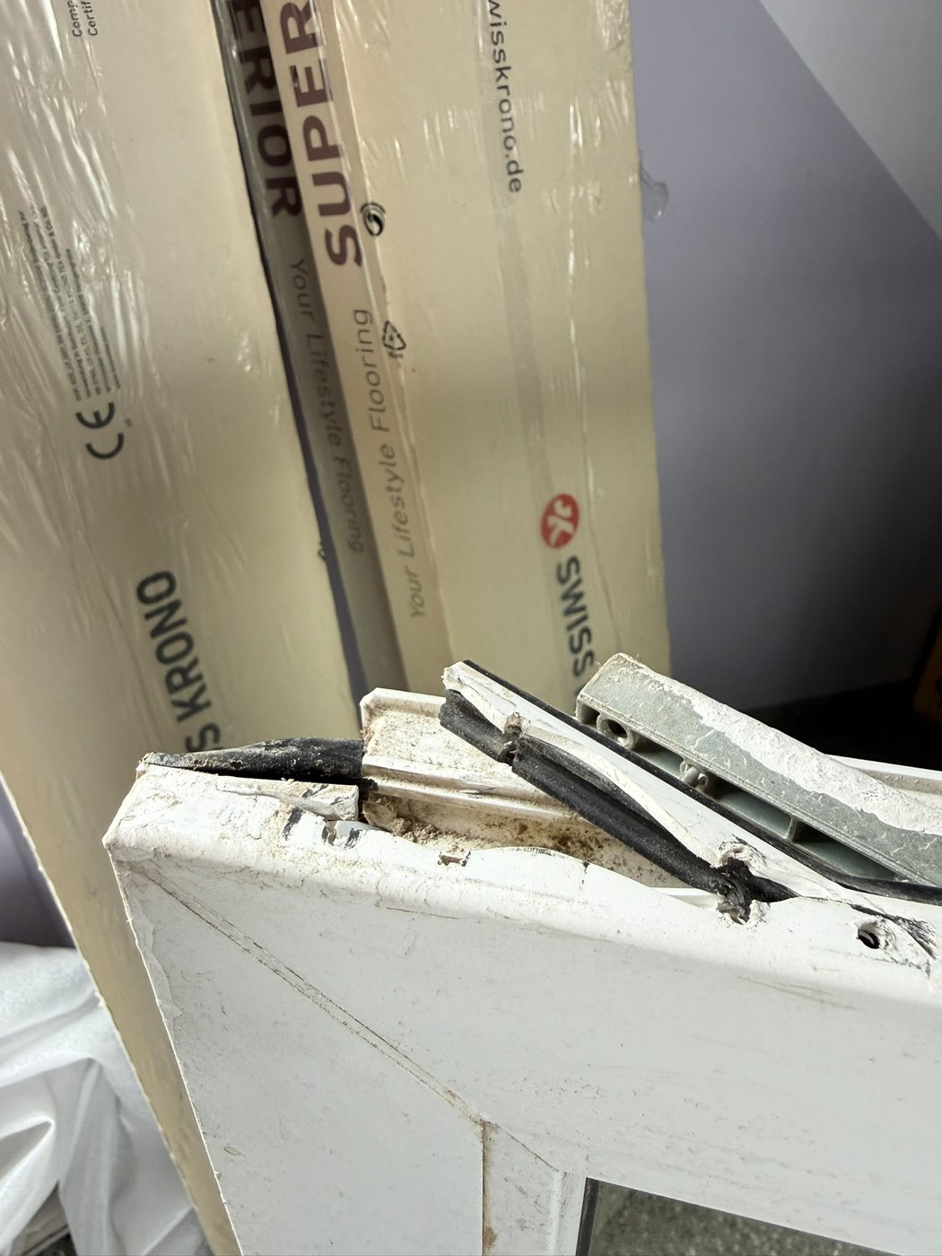 Broken window hinge — torn-out fixing and damaged PVC profile